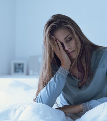 Depressed,Woman,Awake,In,The,Night,,She,Is,Touching,Her