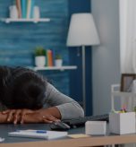 July Blog Post Header Image A woman with her face down on her desk tired and exhausted.